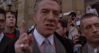 Movie still from “The Punisher” (1989), directed by Mark Goldblatt – A man in a suit and a tie; Close Up shot, Low angle