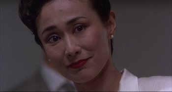 Movie still from “The Punisher” (1989), directed by Mark Goldblatt – A woman's face in a white shirt; Close Up shot, Over the shoulder angle