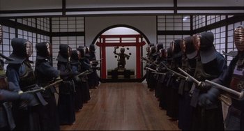 Movie still from “The Punisher” (1989), directed by Mark Goldblatt – A group of people dressed in samurai garb and holding swords; Extreme Wide shot, High angle