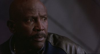 Movie still from “The Punisher” (1989), directed by Mark Goldblatt – An older black man with a goatee looking into the distance; Close Up shot, Low angle