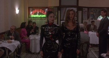 Movie still from “The Punisher” (1989), directed by Mark Goldblatt – A couple of women standing next to each other in a room; Medium shot, Low angle