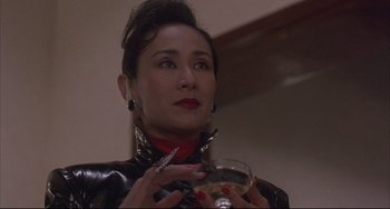 Movie still from “The Punisher” (1989), directed by Mark Goldblatt – A woman holding a wine glass in her hands; Close Up shot, Low angle