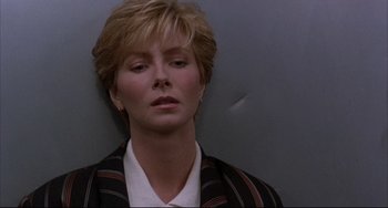 Movie still from “The Punisher” (1989), directed by Mark Goldblatt – A woman with blonde hair and a black jacket; Close Up shot, Low angle