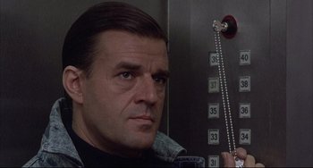Movie still from “The Punisher” (1989), directed by Mark Goldblatt – A person in an elevator; Close Up shot, Low angle