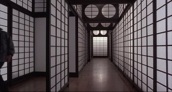 Movie still from “The Punisher” (1989), directed by Mark Goldblatt – A long hallway with a lot of windows on both sides; Extreme Wide shot, High angle