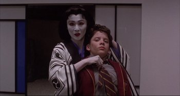 Movie still from “The Punisher” (1989), directed by Mark Goldblatt – A man and a woman dressed in costumes; Medium shot, Over the shoulder angle