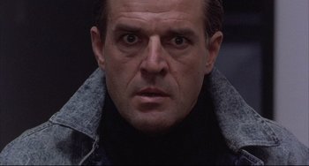 Movie still from “The Punisher” (1989), directed by Mark Goldblatt – A person wearing a black shirt; Close Up shot, Low angle