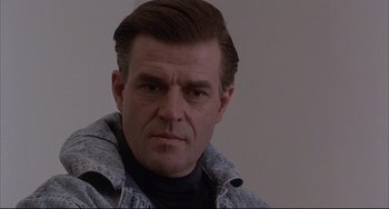 Movie still from “The Punisher” (1989), directed by Mark Goldblatt – A person wearing a jacket; Close Up shot, Low angle
