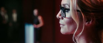 Movie still from “The Purge: Election Year” (2016), directed by James DeMonaco – A person wearing a pair of eyeglasses; Close Up shot, Over the shoulder angle