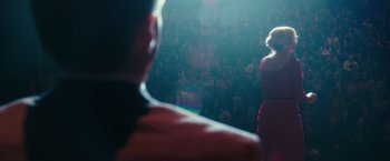 Movie still from “The Purge: Election Year” (2016), directed by James DeMonaco – A crowd of people in a dark room with lights on; Wide shot, Over the shoulder angle