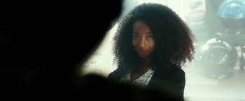 Movie still from “The Purge: Election Year” (2016), directed by James DeMonaco – A person with long curly hair; Close Up shot, Over the shoulder angle