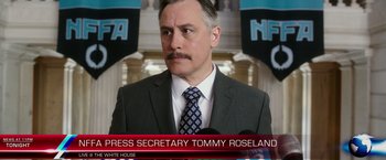 Movie still from “The Purge: Election Year” (2016), directed by James DeMonaco – A person wearing a suit and tie; Close Up shot, Low angle