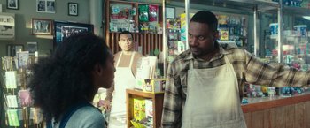 Movie still from “The Purge: Election Year” (2016), directed by James DeMonaco – Two men and a woman in an asian market; Medium shot, Over the shoulder angle