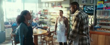 Movie still from “The Purge: Election Year” (2016), directed by James DeMonaco – Two men standing in front of a table in a store; Medium shot, Over the shoulder angle