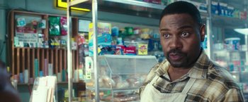 Movie still from “The Purge: Election Year” (2016), directed by James DeMonaco – A person in front of a display of food; Close Up shot, Over the shoulder angle