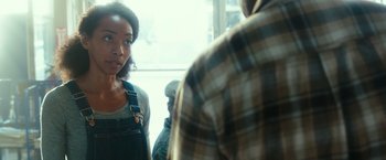 Movie still from “The Purge: Election Year” (2016), directed by James DeMonaco – A woman standing next to a man in front of a window; Close Up shot, Over the shoulder angle