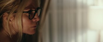 Movie still from “The Purge: Election Year” (2016), directed by James DeMonaco – A person wearing glasses looking out a window; Close Up shot, Over the shoulder angle