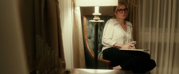 Movie still from “The Purge: Election Year” (2016), directed by James DeMonaco – A woman sitting in a chair in front of a mirror; Medium shot, Over the shoulder angle