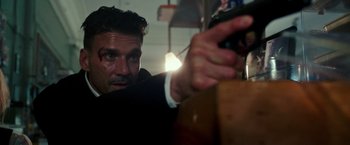 Movie still from “The Purge: Election Year” (2016), directed by James DeMonaco – A person holding a cell phone; Close Up shot, Over the shoulder angle