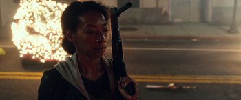 Movie still from “The Purge: Election Year” (2016), directed by James DeMonaco – A woman holding a gun in her hand; Close Up shot, Over the shoulder angle