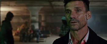 Movie still from “The Purge: Election Year” (2016), directed by James DeMonaco – A person wearing a suit and tie; Close Up shot, Over the shoulder angle