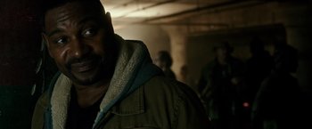 Movie still from “The Purge: Election Year” (2016), directed by James DeMonaco – A person wearing a jacket; Close Up shot, Over the shoulder angle