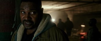Movie still from “The Purge: Election Year” (2016), directed by James DeMonaco – A person wearing a jacket; Close Up shot, Over the shoulder angle