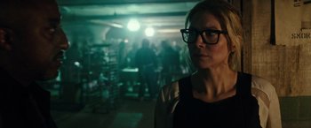Movie still from “The Purge: Election Year” (2016), directed by James DeMonaco – A woman wearing glasses standing in a dark room; Close Up shot, Over the shoulder angle