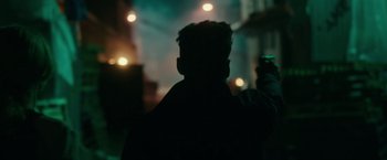 Movie still from “The Purge: Election Year” (2016), directed by James DeMonaco – A man standing in front of a building at night; Close Up shot, Over the shoulder angle