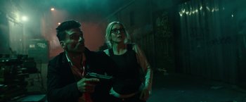 Movie still from “The Purge: Election Year” (2016), directed by James DeMonaco – A man and a woman holding a gun in a dark room; Medium shot, Low angle