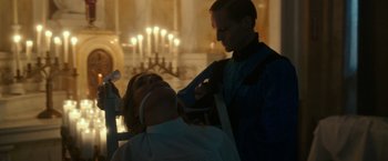 Movie still from “The Purge: Election Year” (2016), directed by James DeMonaco – A woman getting her hair cut by a barber; Medium shot, Low angle