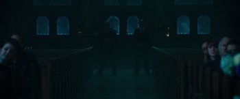Movie still from “The Purge: Election Year” (2016), directed by James DeMonaco – Two men in suits standing in a darkened room; Wide shot, Low angle