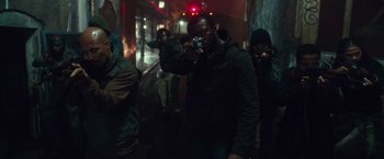 Movie still from “The Purge: Election Year” (2016), directed by James DeMonaco – A group of people walking down a street at night; Medium shot, Low angle