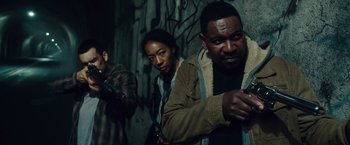 Movie still from “The Purge: Election Year” (2016), directed by James DeMonaco – A group of people standing next to each other in the dark; Medium shot, Low angle