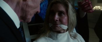 Movie still from “The Purge: Election Year” (2016), directed by James DeMonaco – A woman with bandages around her mouth and nose; Close Up shot, Over the shoulder angle