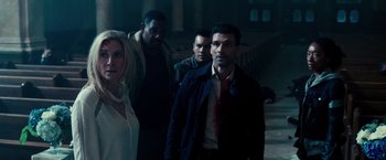 Movie still from “The Purge: Election Year” (2016), directed by James DeMonaco – A group of people standing in a dark room; Medium shot, High angle