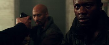 Movie still from “The Purge: Election Year” (2016), directed by James DeMonaco – Two men are standing next to each other in a room; Close Up shot, Over the shoulder angle