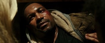 Movie still from “The Purge: Election Year” (2016), directed by James DeMonaco – A person laying on a couch; Close Up shot, High angle