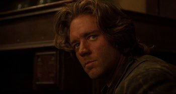 Movie still from “The Quick and the Dead” (1995), directed by Sam Raimi – A person with long brown hair; Close Up shot, Over the shoulder angle