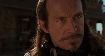 Movie still from “The Quick and the Dead” (1995), directed by Sam Raimi – A person with long hair; Close Up shot, Over the shoulder angle