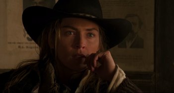 Movie still from “The Quick and the Dead” (1995), directed by Sam Raimi – A person wearing a cowboy hat; Close Up shot, Over the shoulder angle