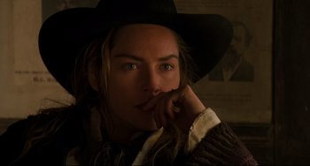 Movie still from “The Quick and the Dead” (1995), directed by Sam Raimi – A person wearing a cowboy hat; Close Up shot, Over the shoulder angle