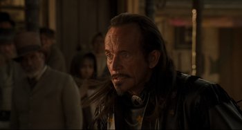 Movie still from “The Quick and the Dead” (1995), directed by Sam Raimi – A person with long hair; Close Up shot, Over the shoulder angle