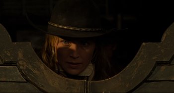 Movie still from “The Quick and the Dead” (1995), directed by Sam Raimi – A woman in a hat looking into a mirror; Close Up shot, Low angle