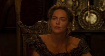 Movie still from “The Quick and the Dead” (1995), directed by Sam Raimi – A woman in a black dress sitting in front of a mirror; Close Up shot, Over the shoulder angle