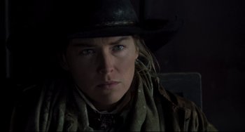 Movie still from “The Quick and the Dead” (1995), directed by Sam Raimi – A person wearing a cowboy hat; Close Up shot, Over the shoulder angle