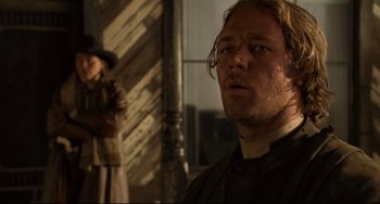 Movie still from “The Quick and the Dead” (1995), directed by Sam Raimi – A person wearing a hat and looking at the camera; Close Up shot, Over the shoulder angle