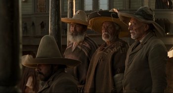 Movie still from “The Quick and the Dead” (1995), directed by Sam Raimi – A group of men wearing hats and standing next to each other; Medium shot, Low angle