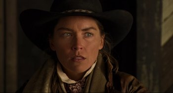 Movie still from “The Quick and the Dead” (1995), directed by Sam Raimi – A person wearing a cowboy hat; Close Up shot, Over the shoulder angle
