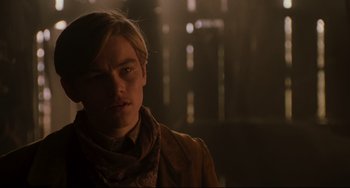 Movie still from “The Quick and the Dead” (1995), directed by Sam Raimi – A young man in a brown jacket looking at the camera; Close Up shot, Low angle